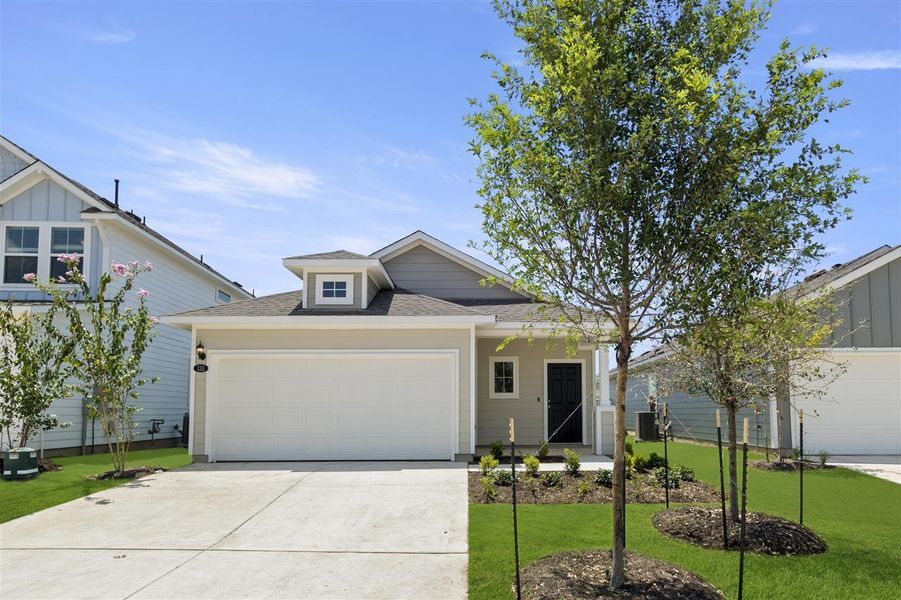 View of front facade with a garage, driveway, central AC unit, and a front lawn