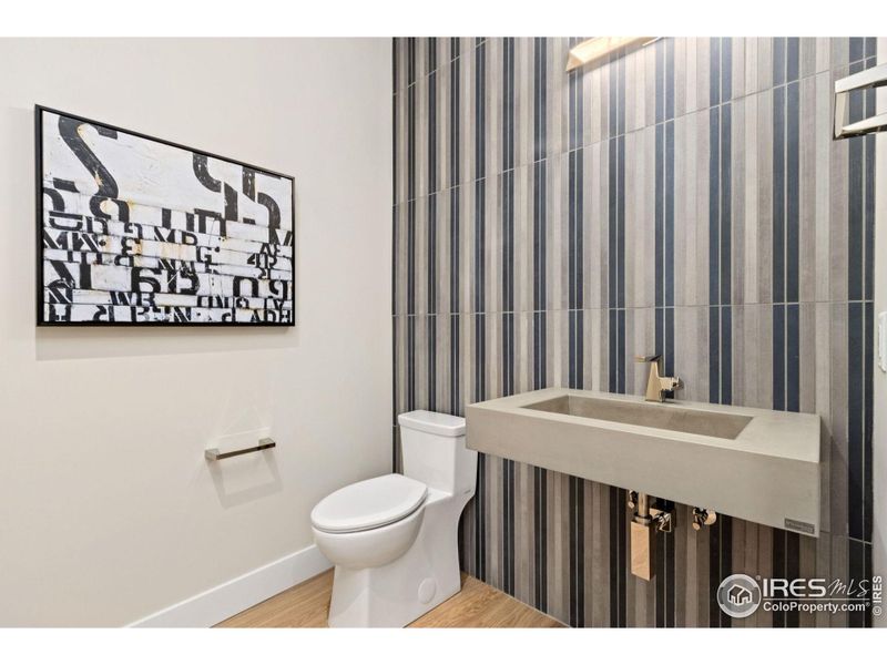 Bespoke tile feature wall in the powder bathroom lends itself to the clean modern lines of this building.