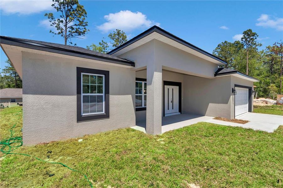 Front exterior of a new home in , Citrus Springs, FL, highlighting curb appeal (Image 13).