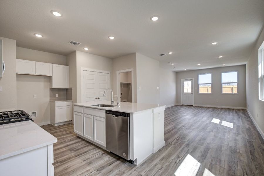 A kitchen with white cabinets.