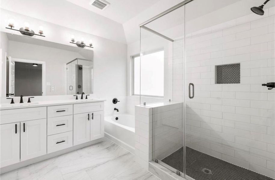 Serene bathroom featuring double sinks, bathtub, separate shower, and a walk-in closet. Serene bathroom featuring double sinks, bathtub, separate shower, and a walk-in closet.