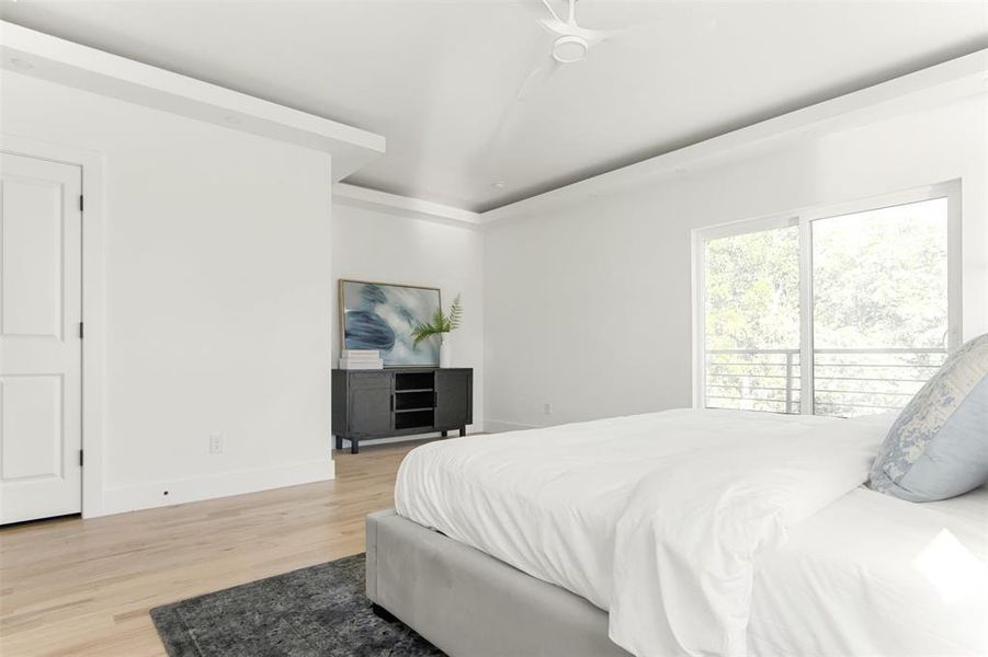 Bedroom with ceiling fan and light hardwood / wood-style flooring