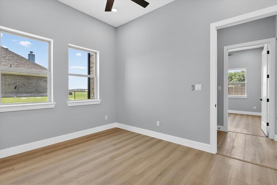 Spacious room with high vaulted ceilings and wood-finish flooring