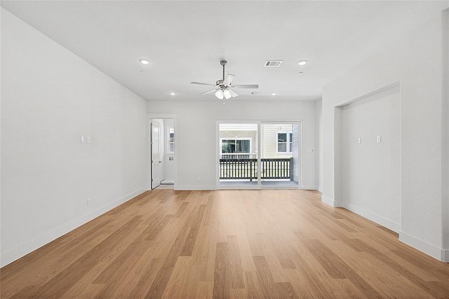 Unfurnished living room with light wood-type flooring and ceiling fan Unfurnished living room with light wood-type flooring and ceiling fan