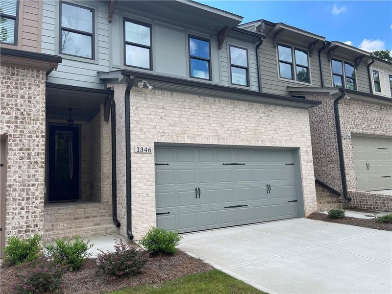 Front exterior of a new home in The Collection at Wolf Creek, Lawrenceville, GA, highlighting curb appeal (Image 1).