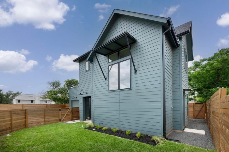 Rear view of property with a fenced backyard and a gate Rear view of property with a fenced backyard and a gate
