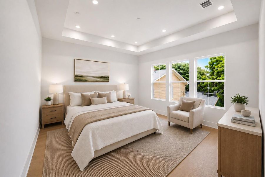 The primary bedroom features a tray ceiling for architectural interest and offers abundant natural light.