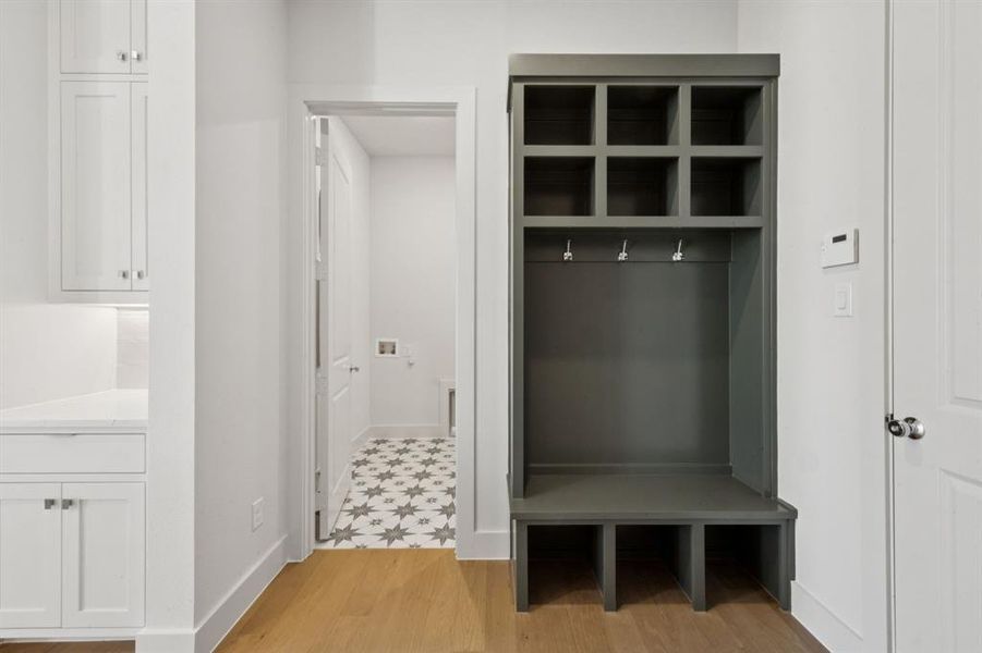 This dream home is outfitted with the perfect owner's entrance featuring a builtin drop zone for the kiddos backpacks and equipment.