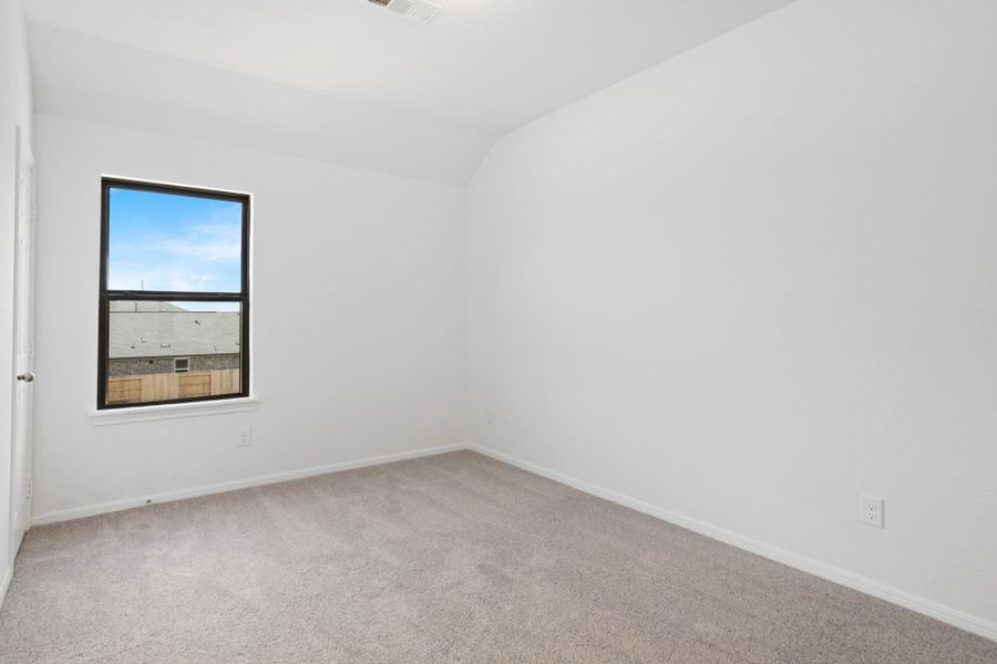 Your secondary bedroom features plush carpet, fresh paint, closet, and a large window that lets in plenty of natural lighting.