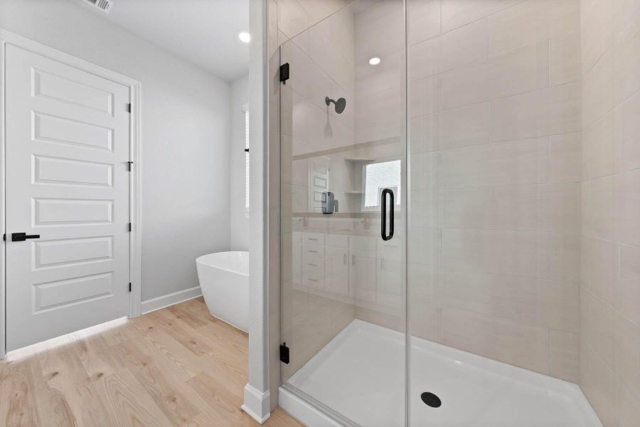 Master bathroom includes granite countertop, elongated mirror, and dual-vanity sinks. Relax in the large soaking tub or enjoy the spacious, standing shower.