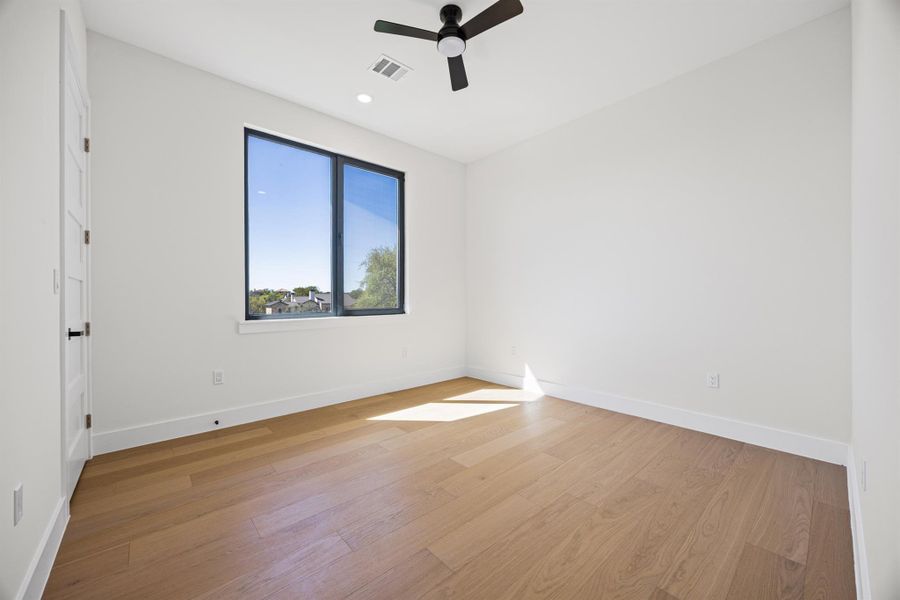 Unfurnished room featuring a ceiling fan, light wood finished floors, and recessed lighting