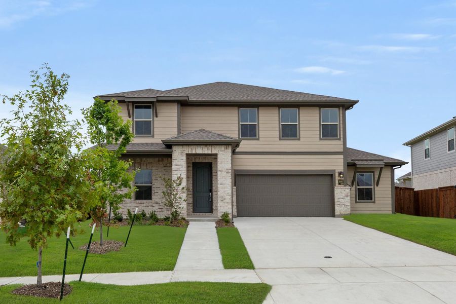 Front exterior of a new home in Waterscape, Royse City, TX, highlighting curb appeal (Image 1). Front exterior of a new home in Waterscape, Royse City, TX, highlighting curb appeal (Image 1).