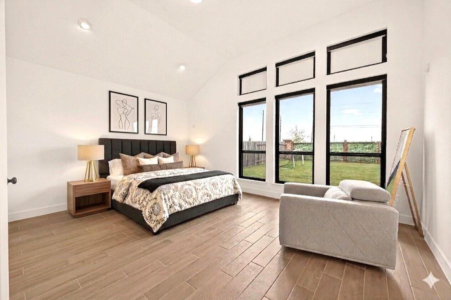 This spacious bedroom features large windows offering plenty of natural light, a modern bed with stylish bedding, and a comfortable seating area. The room has a clean, contemporary design with wood flooring and minimalist decor. Photos have been virtually staged to help illustrate the potential of the space.