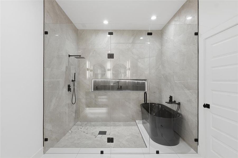 Bathroom featuring a shower stall, a soaking tub, and recessed lighting Bathroom featuring a shower stall, a soaking tub, and recessed lighting