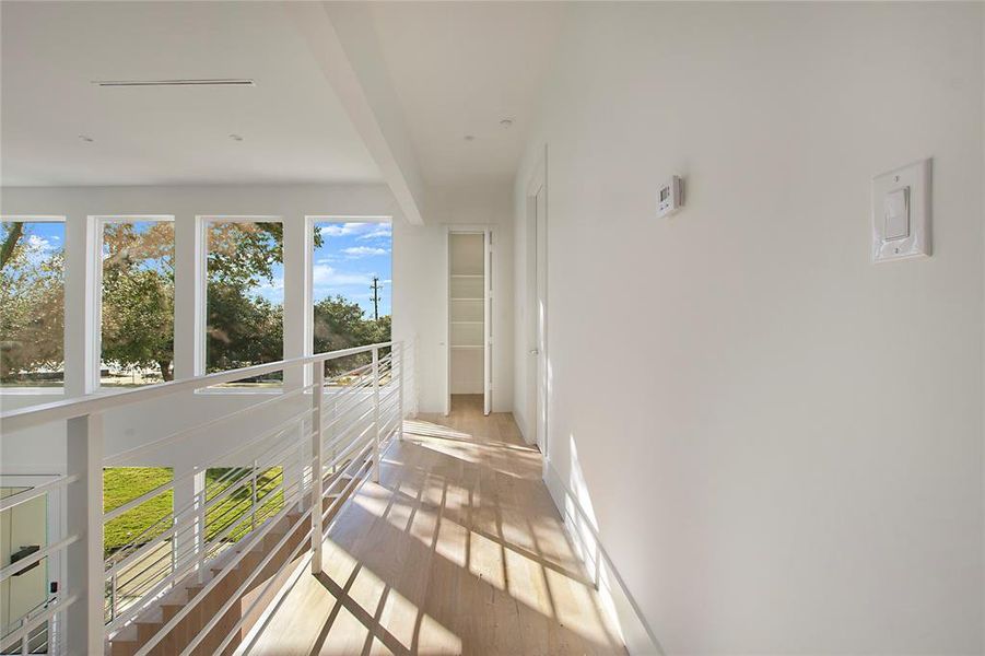 Corridor featuring light hardwood / wood-style flooring and beamed ceiling