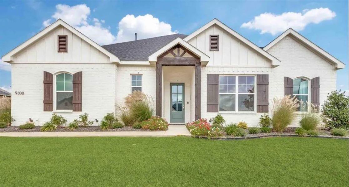 View of front of house featuring board and batten siding and a front lawn View of front of house featuring board and batten siding and a front lawn