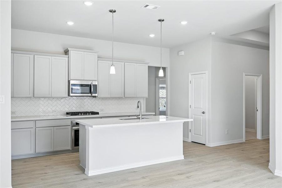 Spare room with light wood-style flooring and baseboards Spare room with light wood-style flooring and baseboards