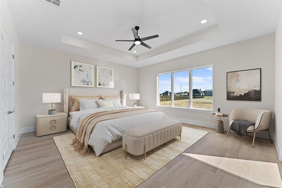Bedroom with light wood finished floors, a tray ceiling, a ceiling fan, and recessed lighting Bedroom with light wood finished floors, a tray ceiling, a ceiling fan, and recessed lighting