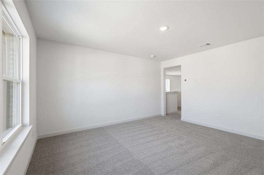 Carpeted empty room with baseboards Carpeted empty room with baseboards