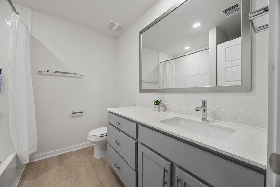 Full bath featuring tub and shower, and vanity