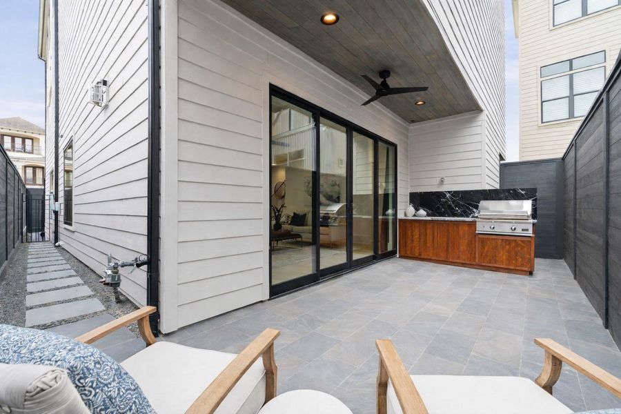 DCS BUILT-IN BBQ W/ CUSTOM CABINETS AND STONE W/ PORCEALAIN PAVERS ON SIDE YARDS
