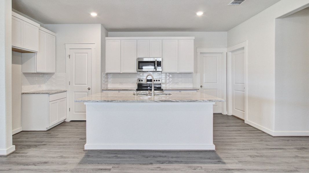 Representative furnished interior of a home built from the Paramount by Brightland Homes in Sunterra, Katy (Image 4).