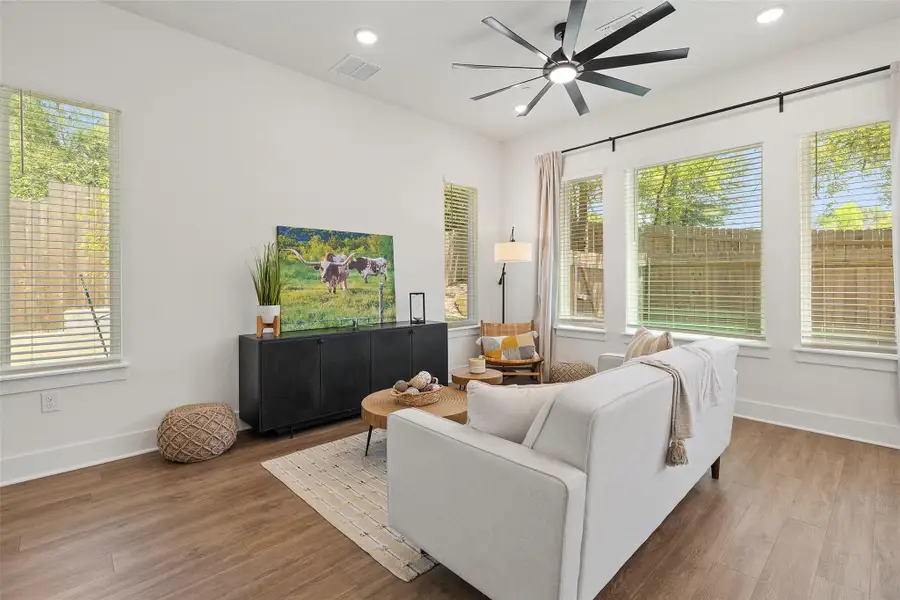 Living area with recessed lighting, wood finished floors, and ceiling fan Living area with recessed lighting, wood finished floors, and ceiling fan