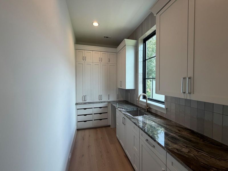 This is the progress photo for the scullery kitchen from August 11. Note we added upper cabinets in place of the open shelving in the rendering. The sink and second dishwasher should be installed shortly.