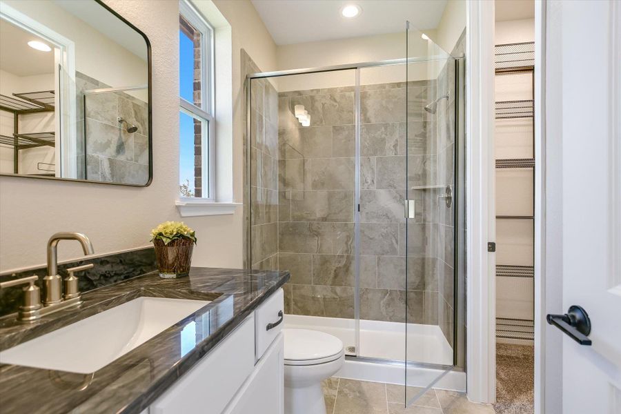 The front bedroom offers an en-suite bathroom and walk-in closet.