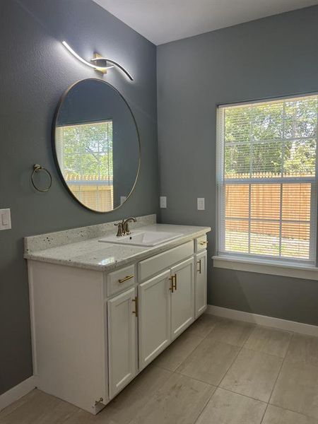 Bathroom featuring vanity and tile patterned floors. Bathroom featuring vanity and tile patterned floors.