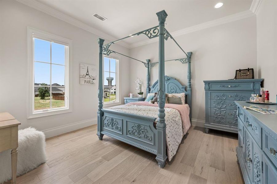 Bedroom featuring multiple windows, ornamental molding, light wood finished floors, and recessed lighting Bedroom featuring multiple windows, ornamental molding, light wood finished floors, and recessed lighting