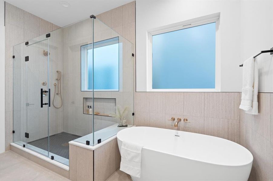 Primary bathroom with separate tub and walk in shower.