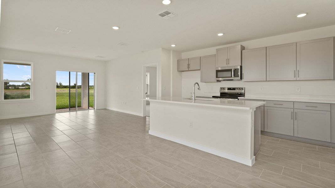 The Naples Living Room and Kitchen Island Quick Move-In Home at Willowbrook North by DRB Homes in Winter Haven, FL The Naples Living Room and Kitchen Island Quick Move-In Home at Willowbrook North by DRB Homes in Winter Haven, FL