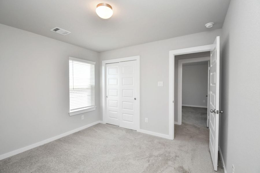 Generously sized secondary bedrooms featuring spacious closets, soft and inviting carpeting underfoot, large windows allowing plenty of natural light, and the added touch of privacy blinds for your personal retreat. Generously sized secondary bedrooms featuring spacious closets, soft and inviting carpeting underfoot, large windows allowing plenty of natural light, and the added touch of privacy blinds for your personal retreat.