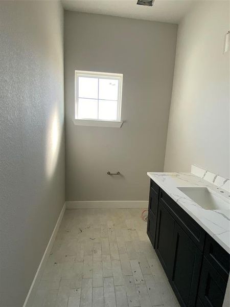 Bathroom featuring vanity and light wood-style flooring Bathroom featuring vanity and light wood-style flooring