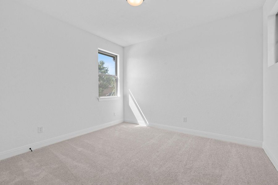 Carpeted empty room with baseboards