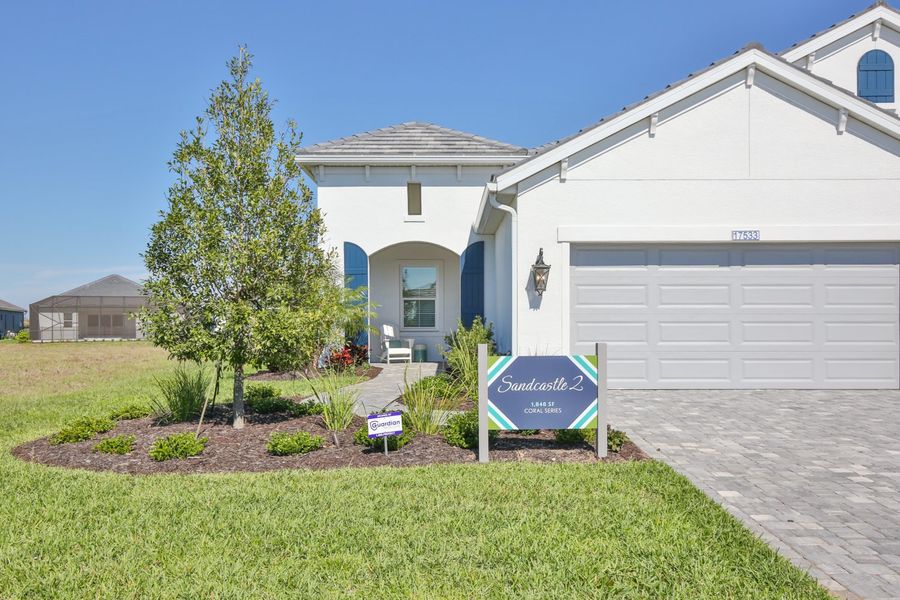 Representative exterior photo of a completed home built from the Sandcastle 2 by Neal Communities in Palm Grove, Lakewood Ranch, FL (Image 1). Representative exterior photo of a completed home built from the Sandcastle 2 by Neal Communities in Palm Grove, Lakewood Ranch, FL (Image 1).