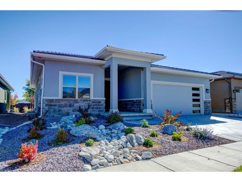Front exterior of a new home in , Loveland, CO, highlighting curb appeal (Image 2). Front exterior of a new home in , Loveland, CO, highlighting curb appeal (Image 2).