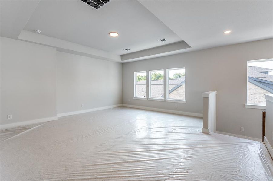 Unfurnished room with a tray ceiling