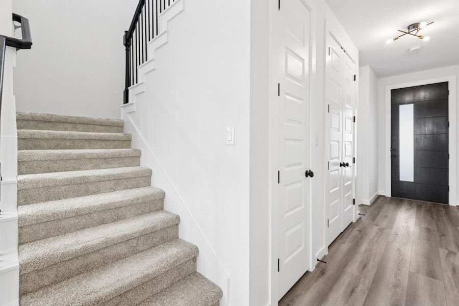 Entrance foyer featuring light wood-style flooring and stairway Entrance foyer featuring light wood-style flooring and stairway