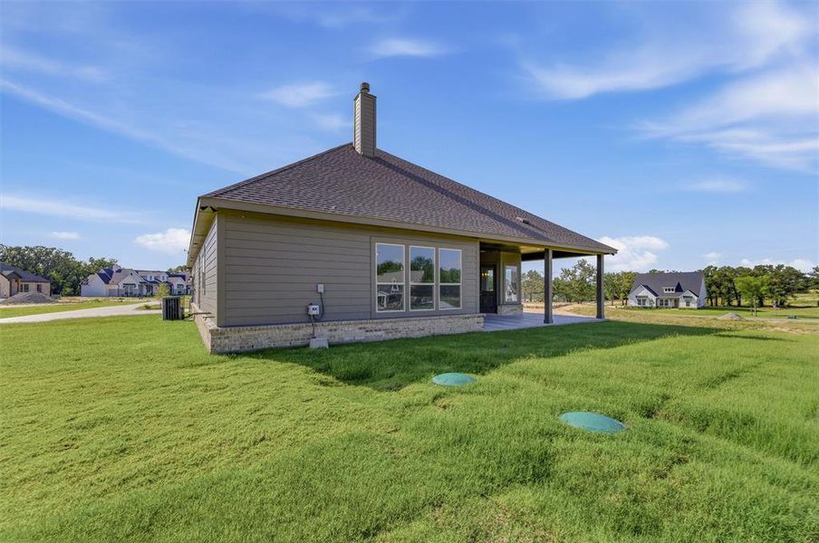 Single-story residence featuring composite shingle roofing, horizontal siding, and a stone foundation Single-story residence featuring composite shingle roofing, horizontal siding, and a stone foundation