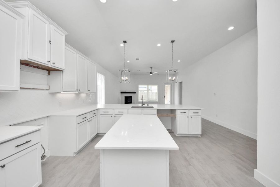 The open concept effortlessly connects the kitchen to the expansive family room, forming a perfect hub for gatherings. This seamless flow creates an inviting space where cooking and socializing come together harmoniously.