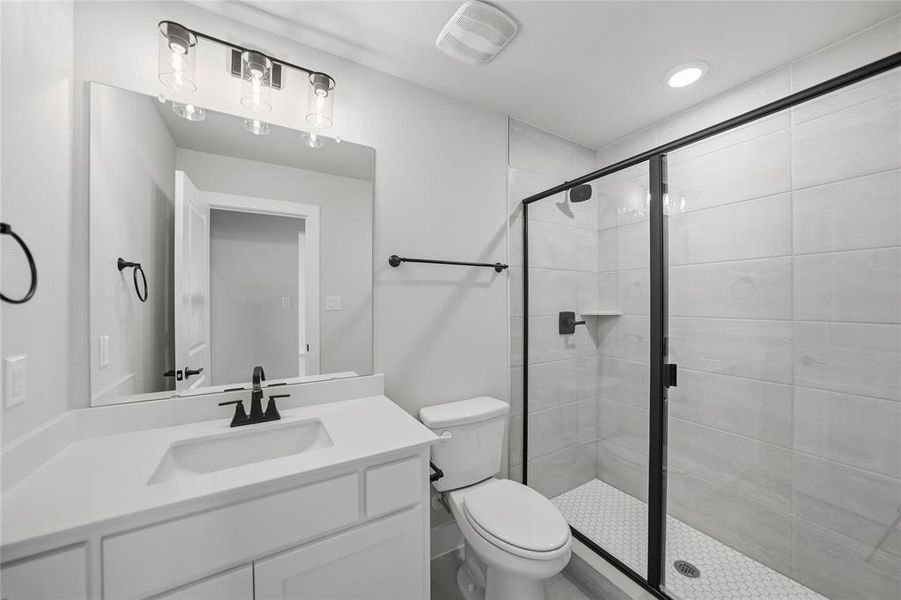 Bathroom featuring vanity, a stall shower, and recessed lighting