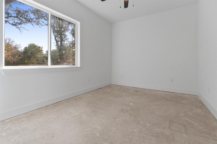 Unfurnished room featuring unfinished concrete floors and a ceiling fan Unfurnished room featuring unfinished concrete floors and a ceiling fan
