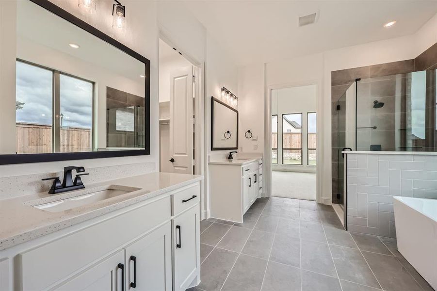 Bathroom with vanity, separate shower and tub, and tile patterned flooring