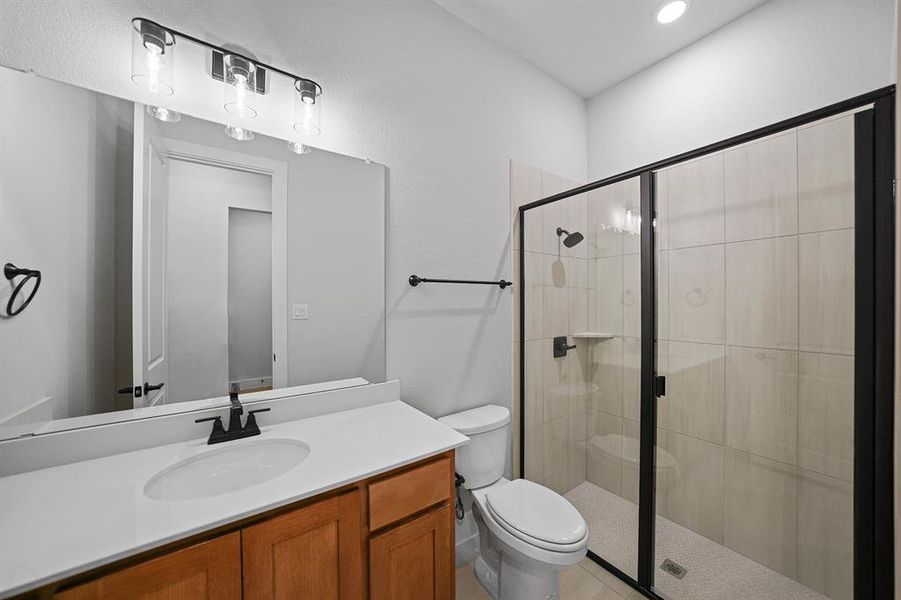 Full bath featuring vanity, a shower stall, and recessed lighting Full bath featuring vanity, a shower stall, and recessed lighting