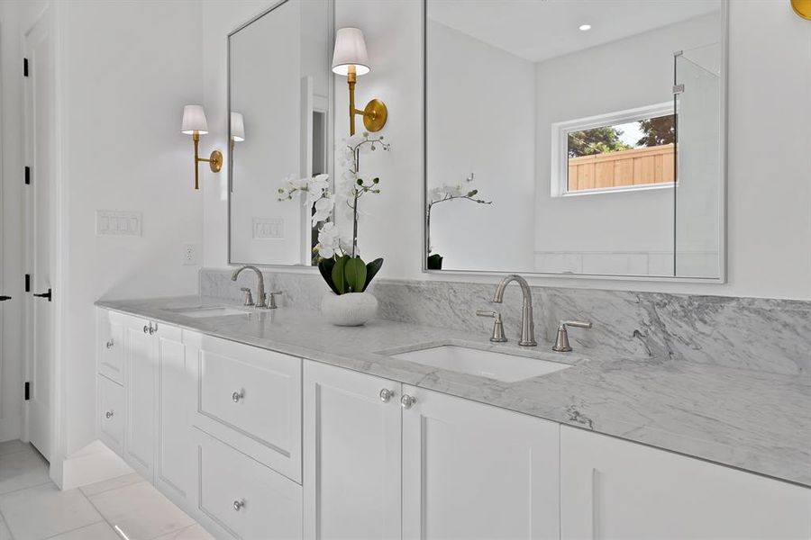 Dual vanity with white cabinetry and integrated sinks