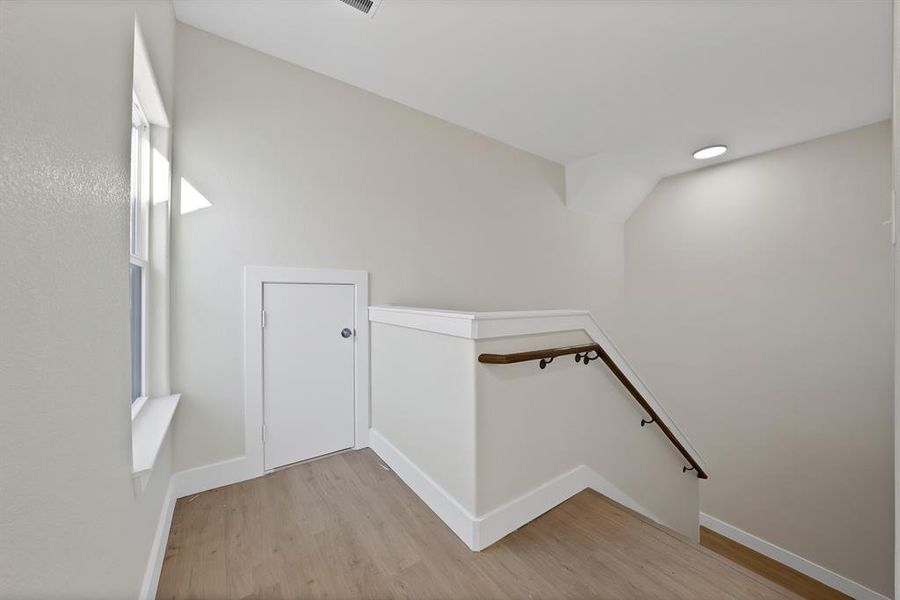 Staircase featuring wood finished floors and baseboards