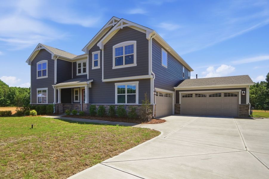 Front exterior of a new home in Blair Place, Monroe, NC, highlighting curb appeal (Image 2). Front exterior of a new home in Blair Place, Monroe, NC, highlighting curb appeal (Image 2).