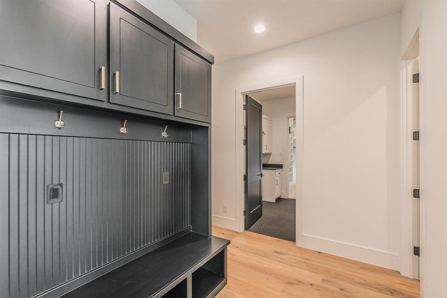 Mudroom with light wood-type flooring and recessed lighting